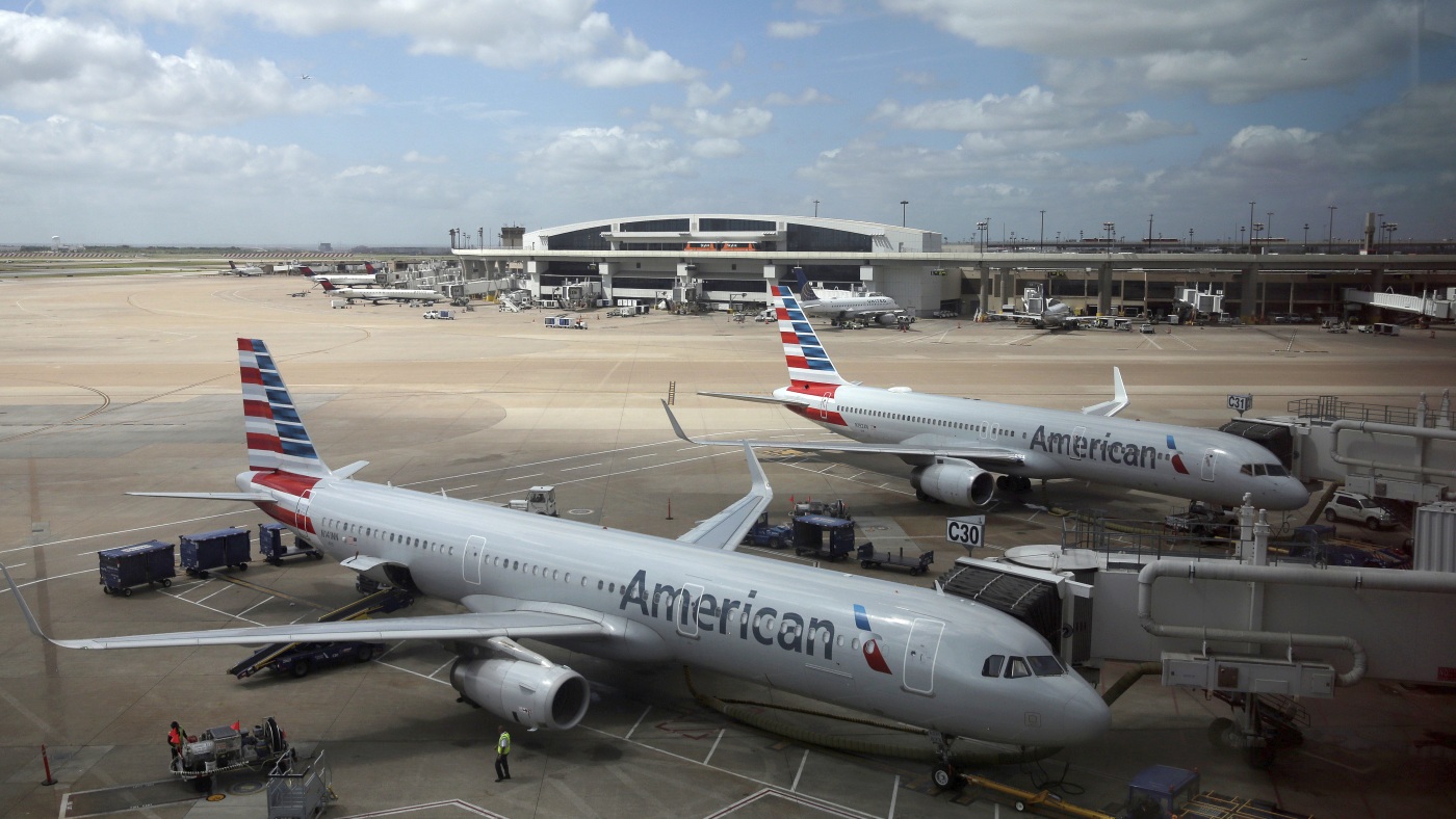 American Airlines faces a discrimination suit after removing 8 Black men from flight : NPR