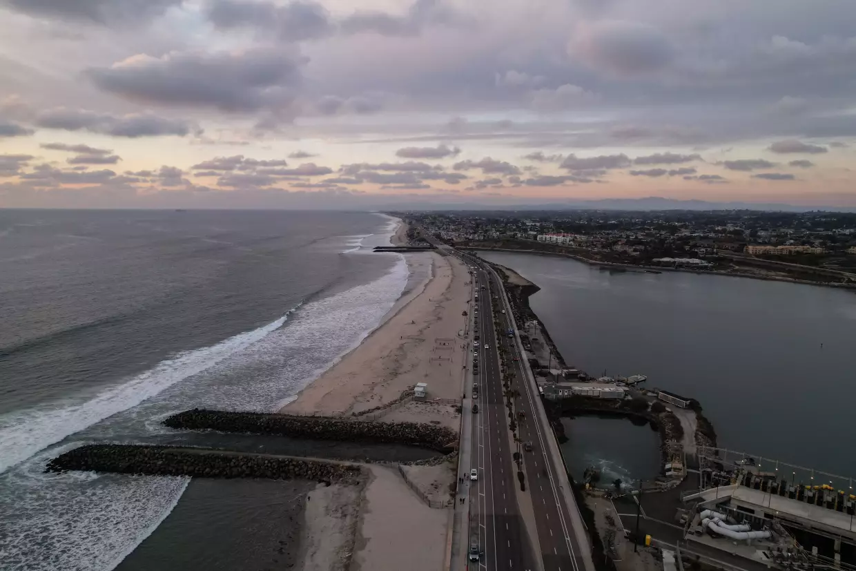A drone view shows the Carlsbad desalination plant's intake lagoon on the right and the discharge canal on the left, Tuesday, Dec. 2, 2025, in Carlsbad, Calif.