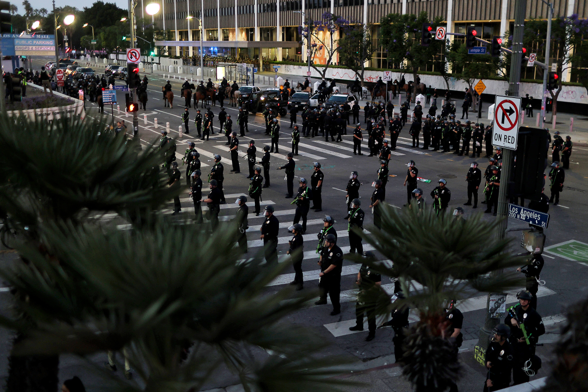 Police officers mobilize to enforce a curfew after it went into effect during a protest against ICE raids on June 10 in Los Angeles.