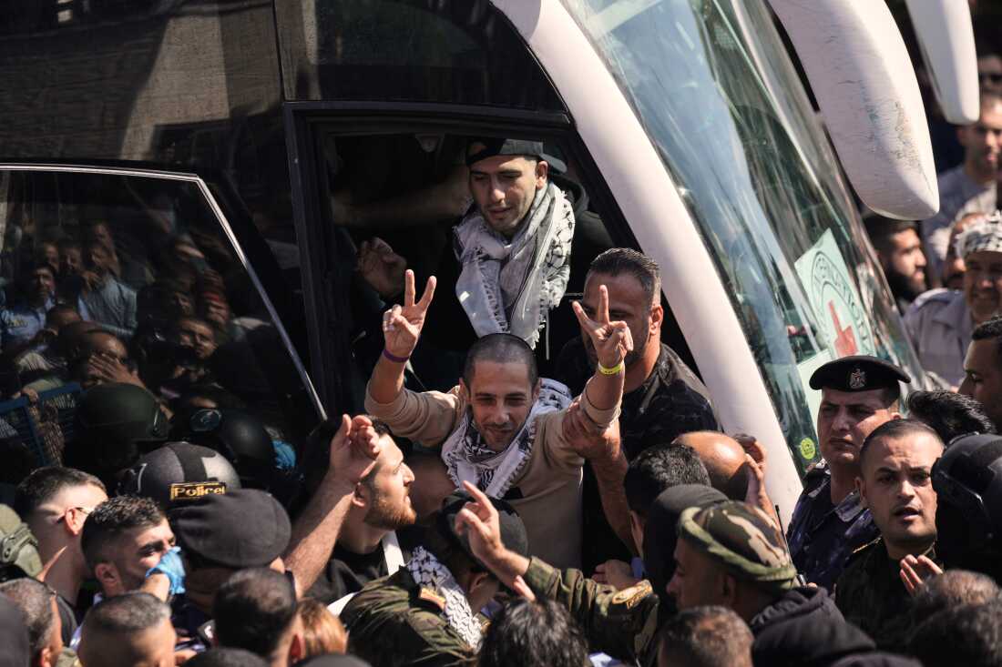 A Palestinian prisoner makes the victory sign after being released from an Israeli prison as part of a ceasefire deal between Israel and Hamas, upon his arrival in the West Bank city of Ramallah on Monday.