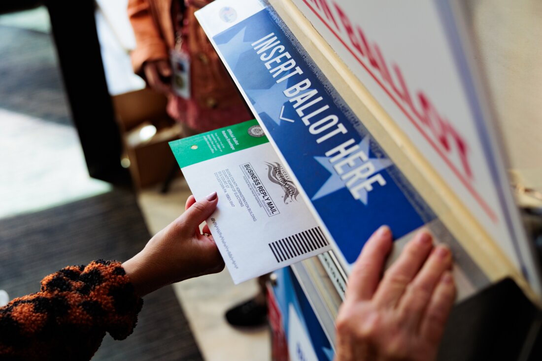 A person drops off a mail-in ballot on Oct. 15 in Doylestown, Pennsylvania. An unknown number of women are hiding their choice of Vice President Harris from family and partners in an election that is projected to have a historic gender gap.