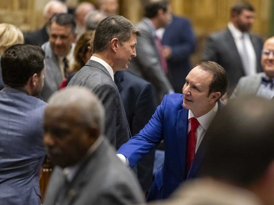 Gov. Jeff Landry shakes hands with representatives while entering the House chamber during the first day of a special session on Monday, Jan. 15, 2024, in Baton Rouge, La.