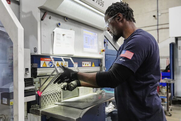 Workers in a manufacturing plant, assembling ⁤components.