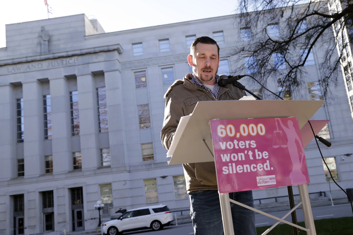 Standing in front of the North Carolina Supreme Court in Raleigh on Jan. 14, Ted Corcoran reads a list of over 60,000 people who cast ballots in the November 2024 election but whose votes have been challenged by Republican court candidate Jefferson Griffin in his extremely close race with Democratic Justice Allison Riggs.