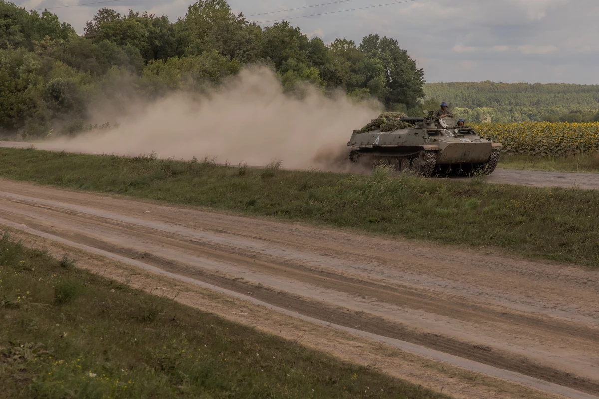 Ukrainian servicemen ride an armored fighting vehicle in the Sumy region, near Ukraine’s northeastern border with Russia on Sunday. Ukrainian troops in this area crossed into western Russia last week and have seized a large swath of territory.