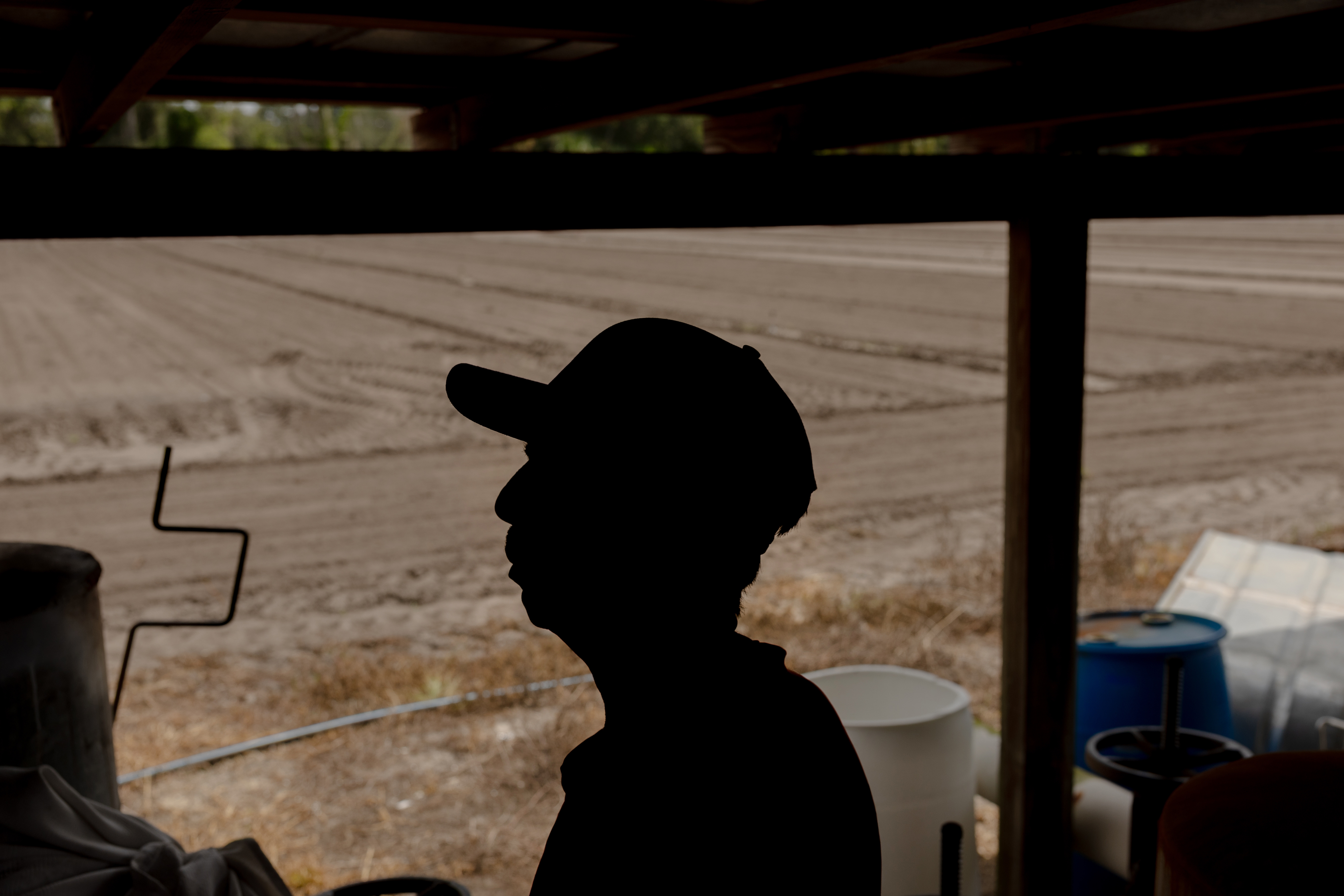 A farmer poses for a portrait near his fields on July 19 in Tampa. The labor market in Central Florida has changed over the past few months, as many migrants fear leaving their homes and are working less or leaving Florida altogether.