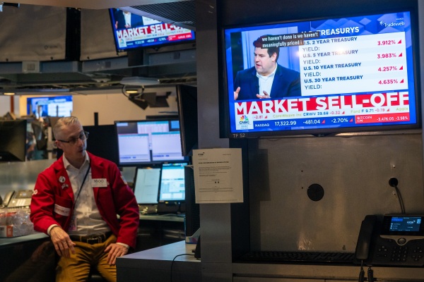 Traders work on the floor of the New York Stock Exchange on March 28, 2025. President Trump's escalating tariff threats have hit stock prices hard.