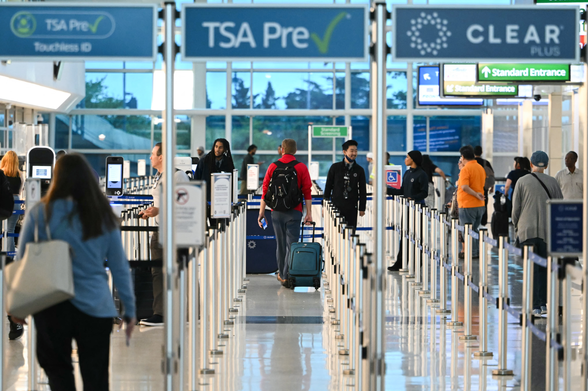 Passengers walk through security lines at Reagan National Airport on the first day of the U.S. government shut down in Arlington, Va. Efforts to bring a quick end to the shutdown stalled Wednesday.