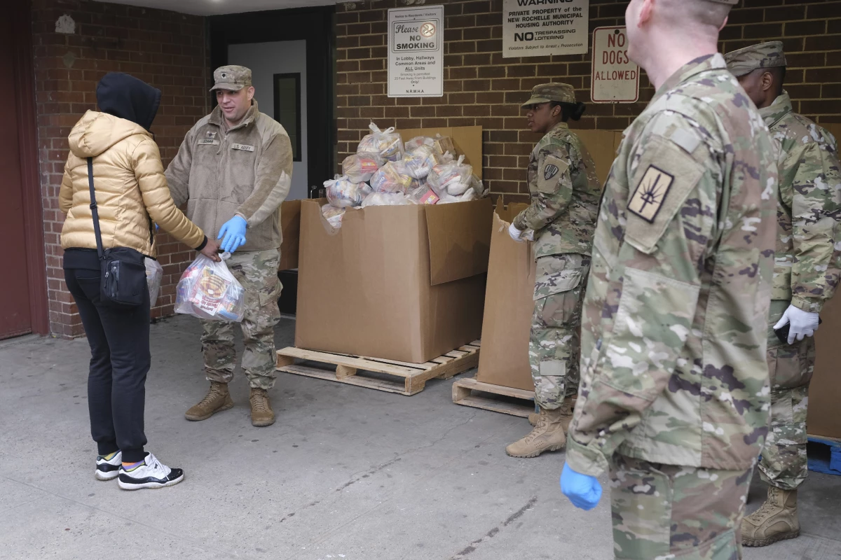 Members of the New York National Guard distribute food to families in New Rochelle, N.Y., on March 12, 2020.