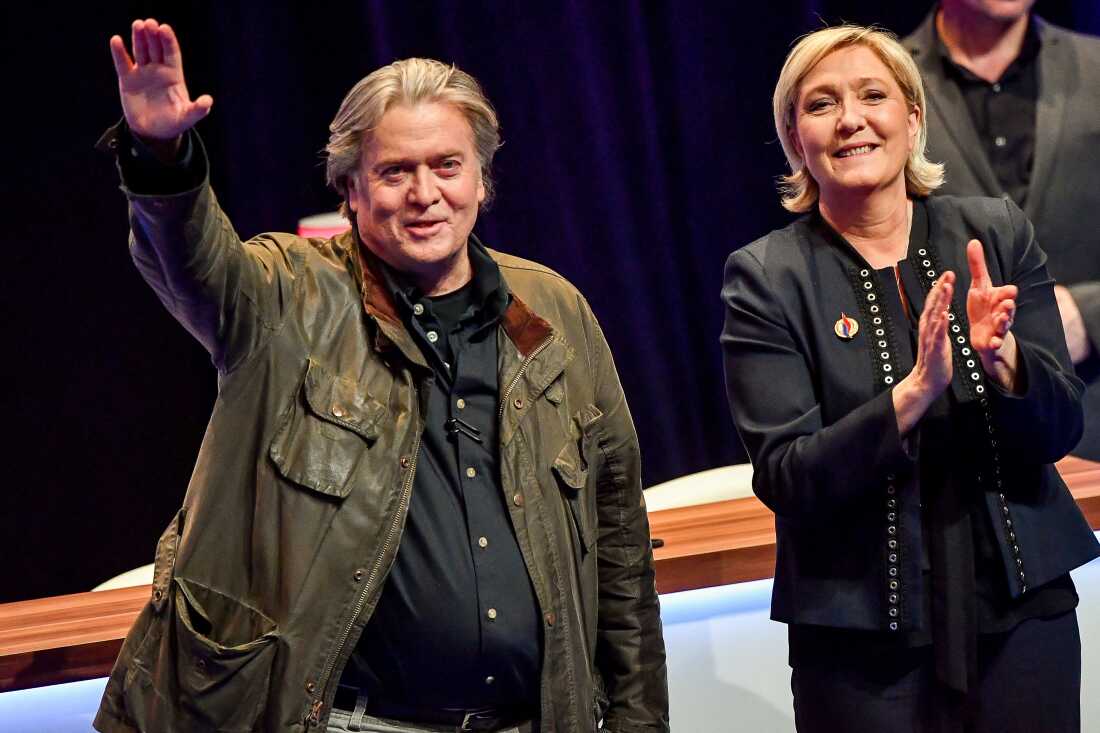 France's far-right party Front National President Marine Le Pen (right), applauds former presidential advisor Steve Bannon after his speech during the party's annual congress, on March 10, 2018 at the Grand Palais in Lille, northern France.