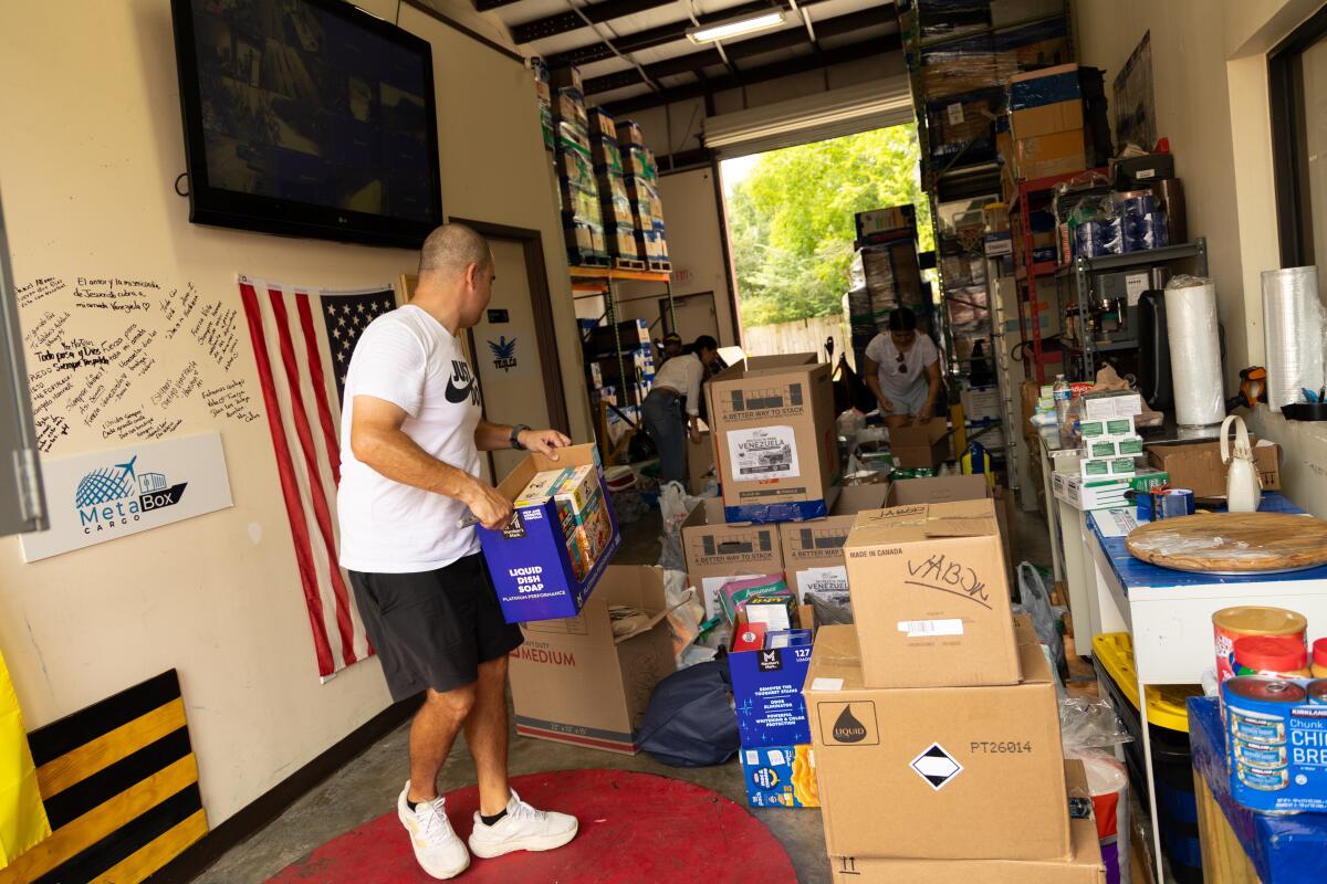 Jesus Nunez, owner of MeetaBox Cargo in Katy, Texas, helps sort donated food, hygiene supplies and other essentials during a donation drive on Thursday.