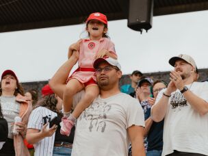 A young fan dons a Rockford Peaches uniform — a nod to one of the All-American Girls Professional Baseball League's teams that inspired the 1992 film <em>A League of Their Own</em> — at opening day on Saturday, Aug. 1.