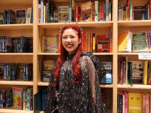 Ivana Wong's black dress adorned with sequin stars, a silver headpiece and a sheer, flowy cape won the night's costume contest.