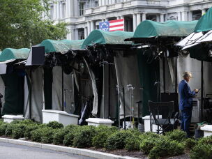 White House TV correspondents prepare to go live as the CNN booth is empty on the White House grounds on September 21, 2026 in Washington, DC.