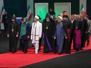 Iranian religious leaders and other mourners walk past the coffins of slain Iranian Supreme Leader Ayatollah Ali Khamenei and members of his family during a viewing ceremony ahead of the dayslong funeral ceremonies at the Imam Khomeini Mosalla Grand Mosque in Tehran, Iran, Friday, July 3, 2026.