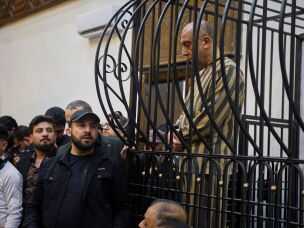FILE -Atef Najib, former head of the Political Security Branch in the Daraa area during Bashar Assad's rule, sits in the defendants' cage during a trial session at the Palace of Justice in Damascus, Syria, April 26, 2026.