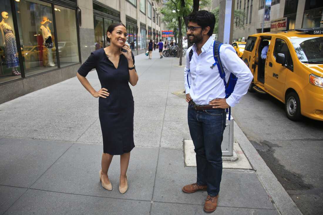 Alexandria Ocasio-Cortez, left, the winner of the Democratic primary in New York's 14th Congressional District, speaks on a phone as Saikat Chakrabarti, her senior campaign adviser stands by, Wednesday, June 27, 2018, in New York. The 28-year-old political newcomer upset U.S. Rep. Joe Crowley, says she brings an "urgency" to the fight for working families. (AP Photo/Bebeto Matthews)