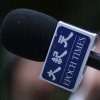 Money laundering charges shake up The Epoch Times management : NPR 3 A reporter for The Epoch Times holds a microphone during a media event on Oct. 23, 2023 in Berlin, Germany. The Epoch Times is owned by Epoch Media Group and is affiliated with the Falun Gong movement. The organization's chief financial officer was indicted by federal prosecutors on June 3, 2024 on allegations of money laundering.