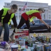 Volunteers organize donated beans, powered milk and other nonperishable items during a food drive in front of the U.S. Department of Agriculture on Thursday in Washington, D.C. The food drive and political rally brought together faith leaders, food bank workers and furloughed federal employees who demanded that the Trump administration release billions in emergency funds for the Supplemental Nutrition Assistance Program.