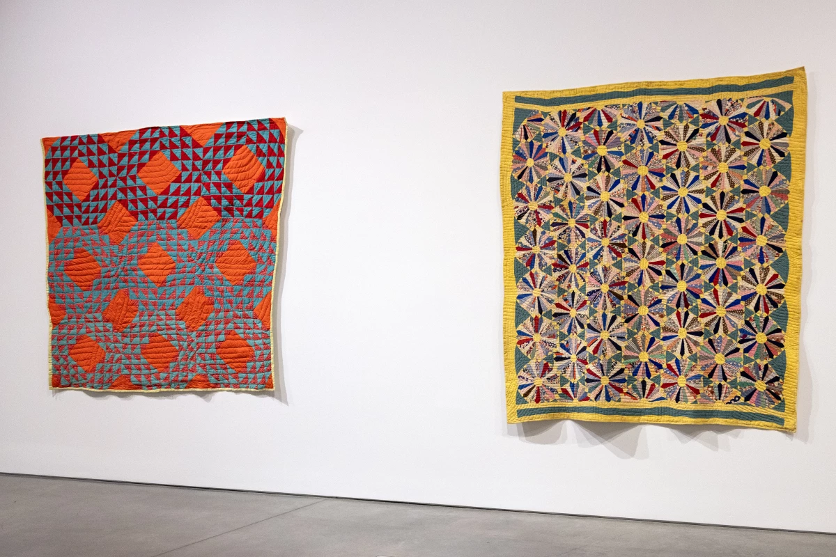 Quilts on display at BAMPFA. [Left] Beauty Earnestine Vaughns, Untitled (Ocean Wave); Bequest of the Eli Leon Living Trust, BAMPFA; Courtesy of Douglas Washington, grandson of the quiltmaker; [Right] Pearl Nunley and Beauty Earnestine Vaughns, Flower Garden (Sunflower Variation); Bequest of the Eli Leon Living Trust, BAMPFA‬; Courtesy the Descendants of Pearl Nunley.