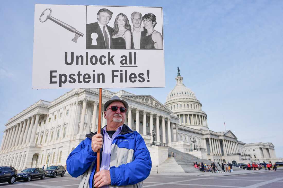 Gary Rush, of College Park, Md., holds a sign before a news conference on the Epstein files in front of the Capitol, on Tuesday, Nov. 18, 2025, in Washington, D.C.