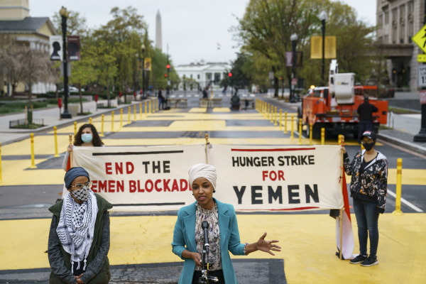 With Iman Saleh (left), on her 12th day of a hunger strike for Yemen, looking on, Rep. Ilhan Omar, D-Minn., speaks during a press conference at Black Lives Matter Plaza calling for an end to U.S. support for a Saudi Arabia-led blockade of Yemen on April 9, 2021.