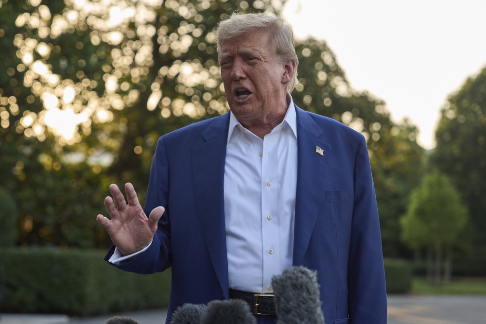 President Trump speaks with reporters before boarding Marine One on the South Lawn of the White House, Tuesday. (AP)