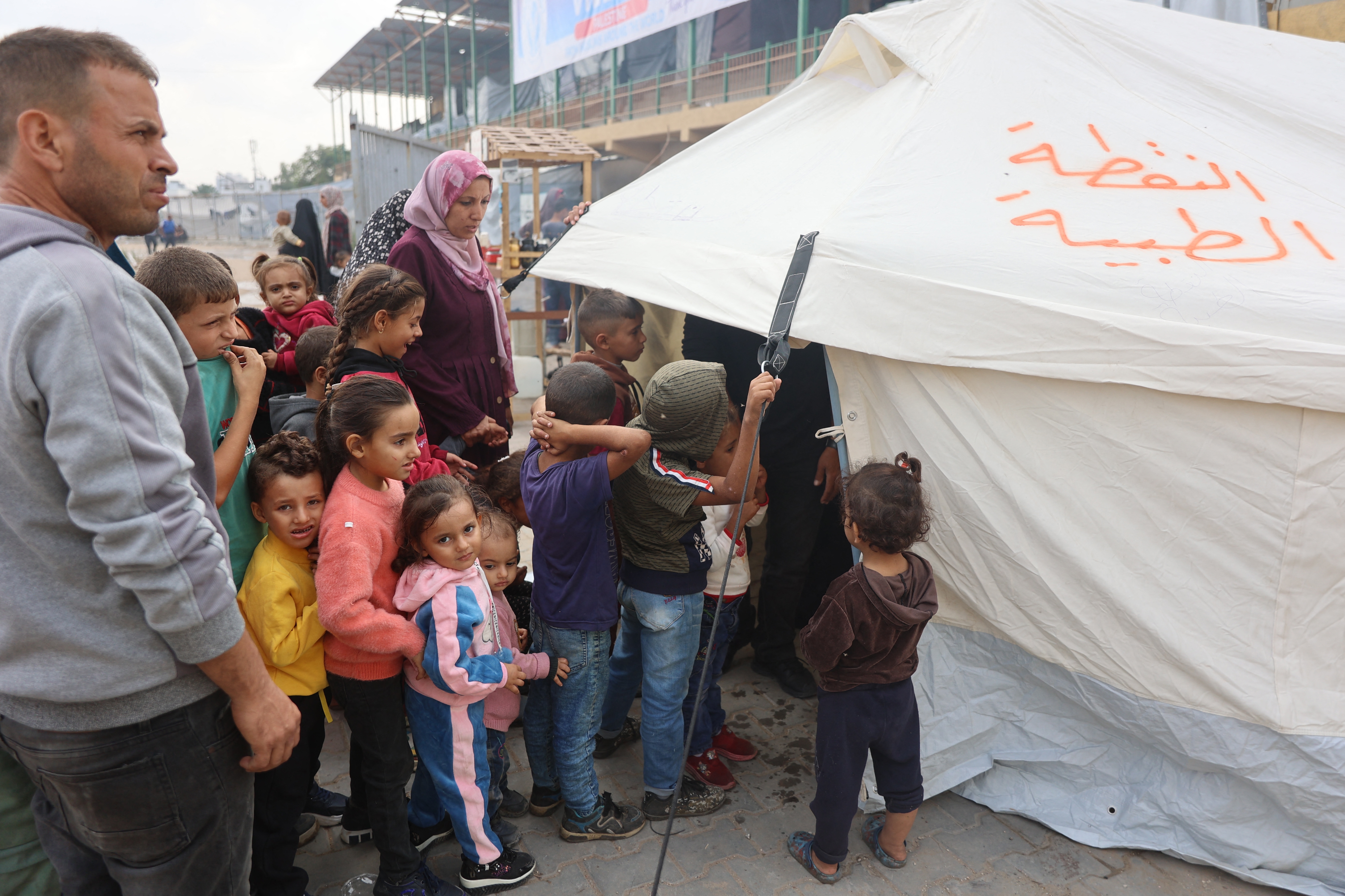 Palestinian children queue outside a tent for the second phase of polio vaccination at Abdel Aziz Rantissi hospital in Gaza City