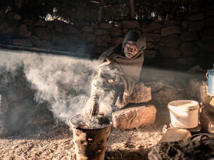 Khotso Rants'etile, 22, who has been working as a herder since the age of nine, prepares breakfast in his isolated cattle post in the mountains of Mokhotlong District, Lesotho.