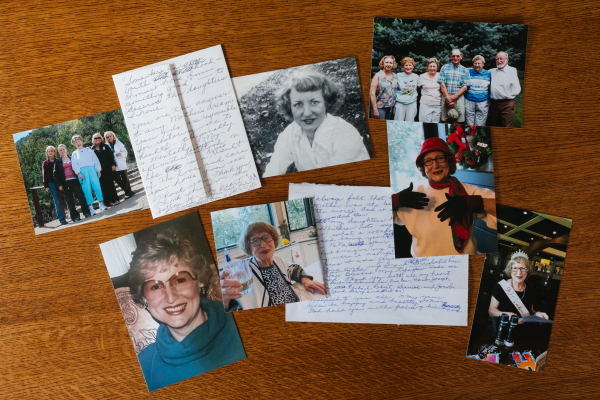 Photographs of Gladys Lynch at different points in her life are arrayed on a table, along with letters.