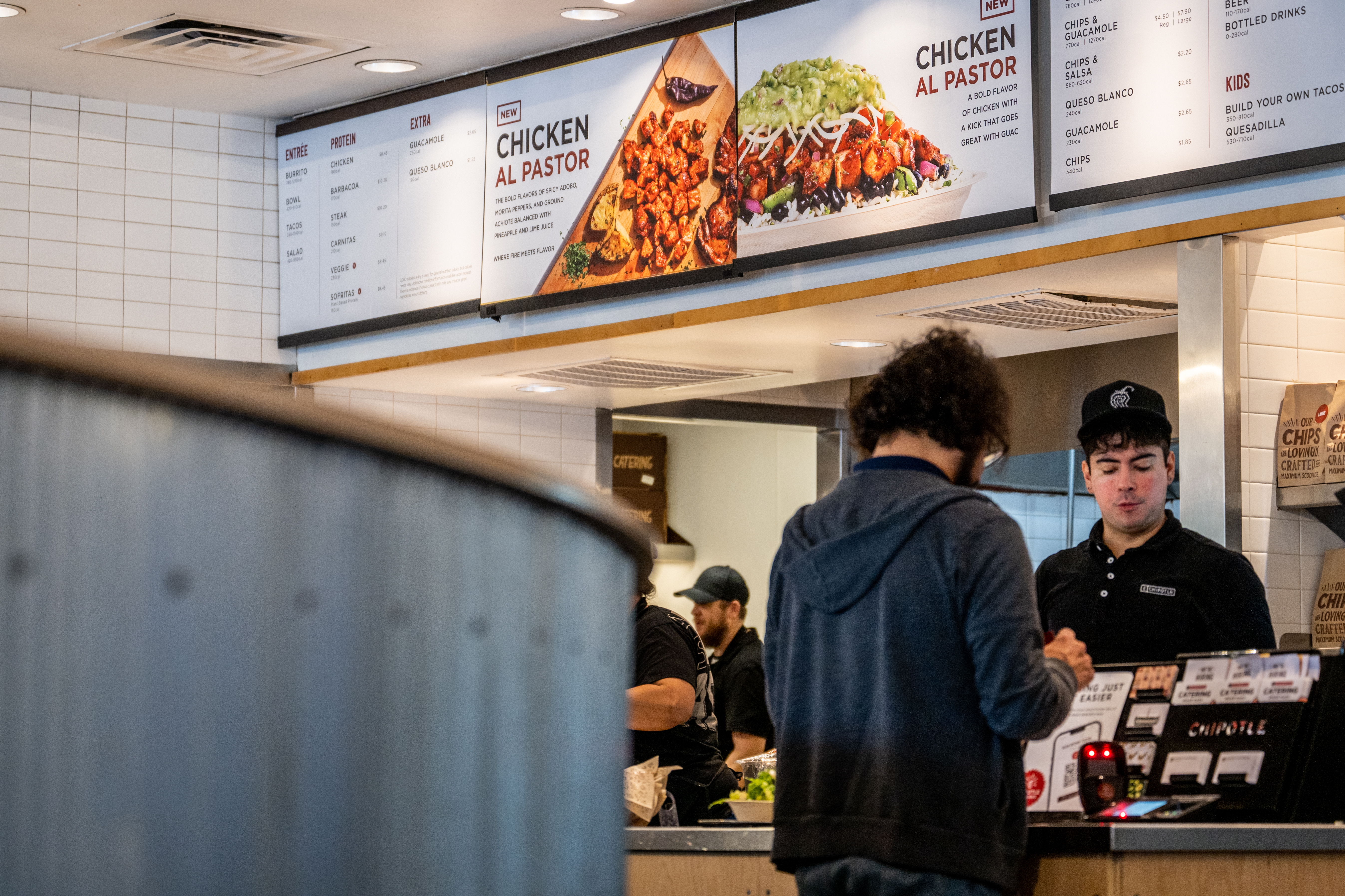 A customer pays for their food at a Chipotle Mexican Grill restaurant in Austin, Texas. Chipotle says its portion sizes have not shrunk, despite complaints shared on social media.