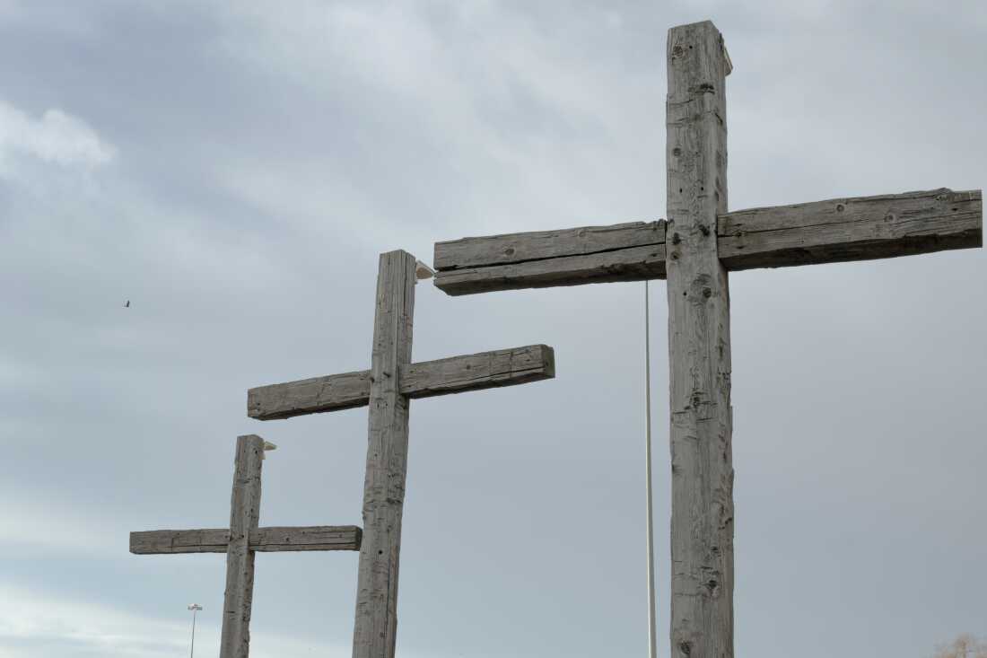 Crosses stand in front of a church at the entrance of North Platte, Sunday, Dec. 22, 2024, in North Platte, Nebraska. (Lexi Parra for NPR)