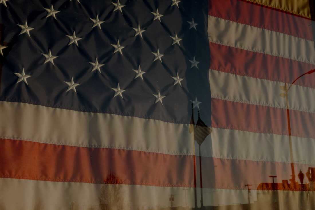 A framed U.S. American flag is on display in downtown, Saturday, Dec. 21, 2024, in Fremont, Nebraska. Immigrant workers, primarily from El Salvador and Guatemala, have been moving to Nebraska, where there are multiple factories and jobs.