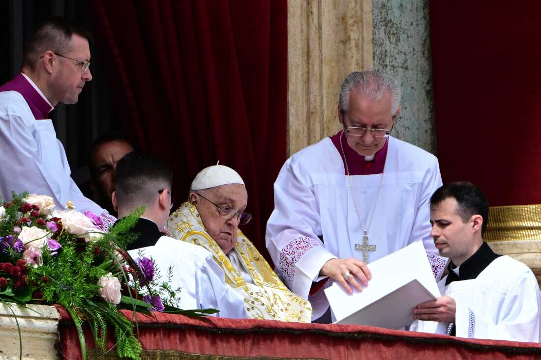 Pope Francis addresses the crowd from the main balcony of St. Peter's Basilica on Sunday.