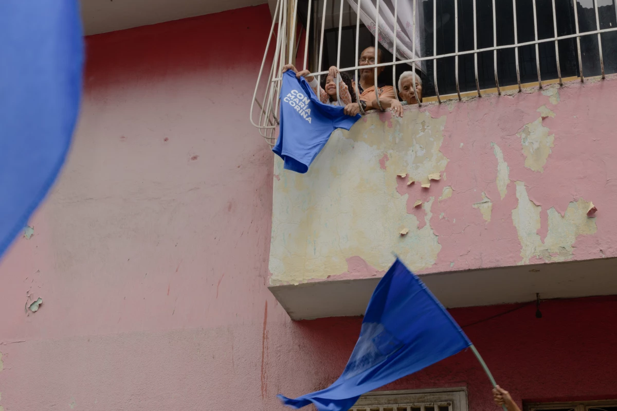Residents wave a T-shirt with the name of Venezuelan opposition leader María Corina Machado in support of a campaign march in La Vega, a neighborhood of Caracas, on Wednesday.