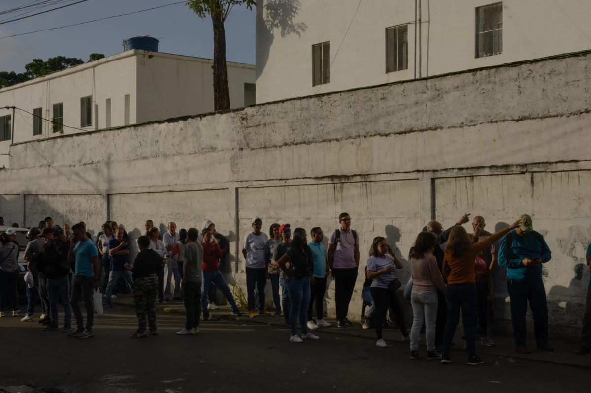 People prepare to vote in the Venezuelan presidential elections early in the morning on Sunday, in the capital city of Caracas. This voting center in Gato Negro, Catia, is where President Maduro cast his ballot. All over the country, people began waiting in lines outside their voting centers as early as 10 p.m. the night before.