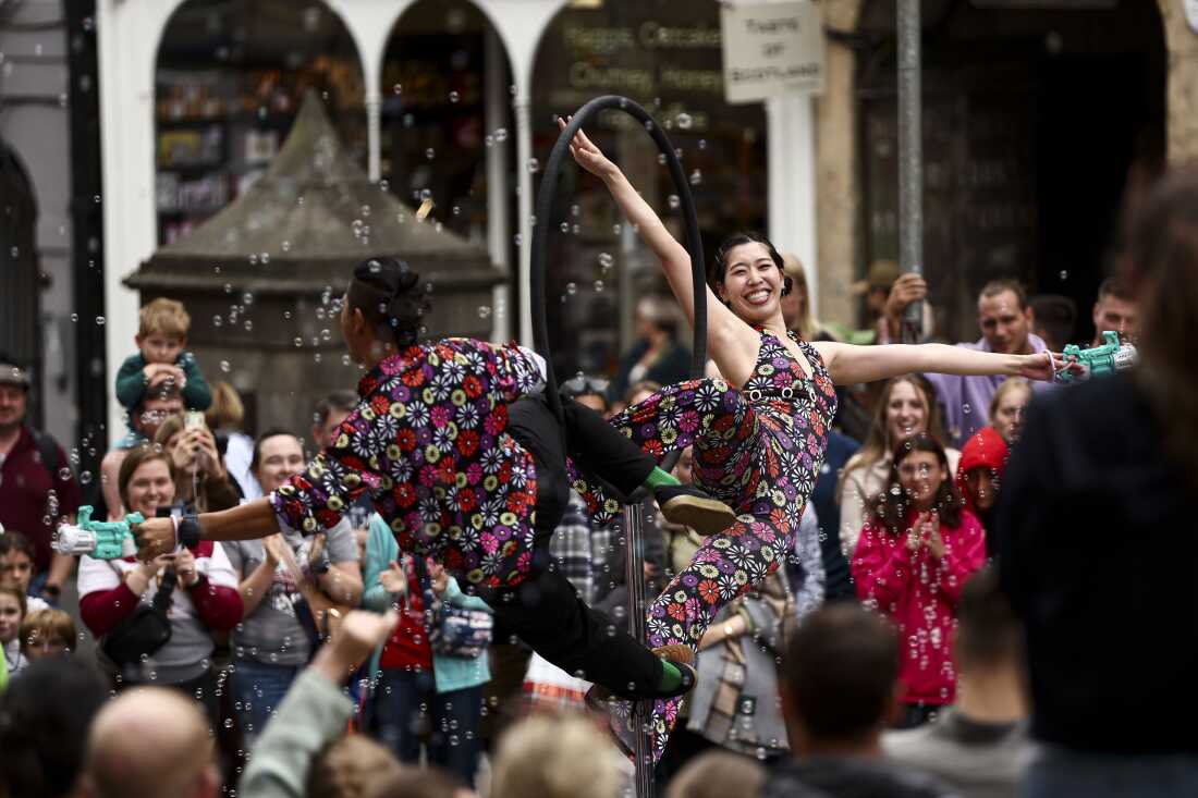 Street performers entertain passersby on the Royal Mile as crowds of entertainers and festival-goers gather for the Edinburgh Festival Fringe and Edinburgh International Festival in Edinburgh, Scotland, on Aug. 1, 2025. The Fringe, one of the world's largest performing arts festivals, features over 3,800 shows across 265 venues and draws an audience of roughly 3 million visitors.