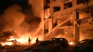 Emergency services personnel work to extinguish a fire following Russian missile attacks in Kyiv, Ukraine, Monday, July 6, 2026.