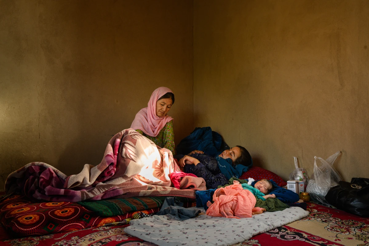 Gulshaman visits Fatemah, whose daughter, Yasmin, was born the previous day. Waras, Shahristan district, Daikundi province, Afghanistan. July 27, 2025