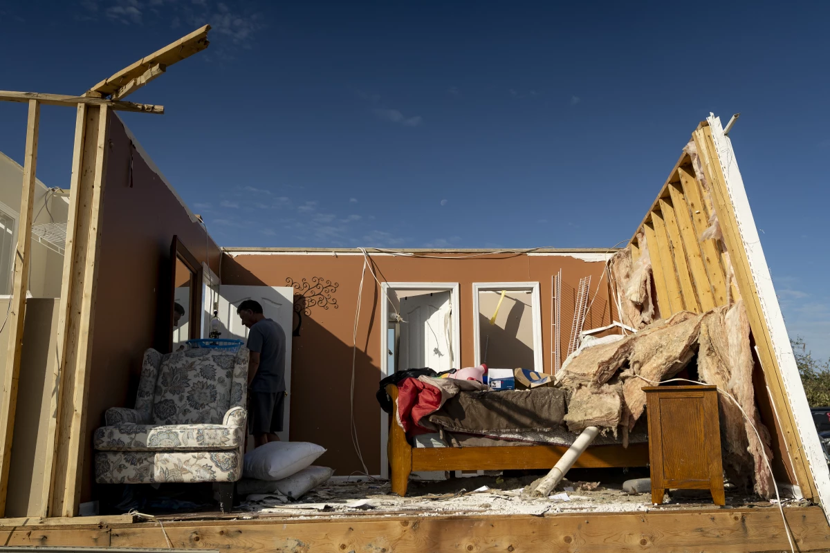 A person walks through a house in the community of Sunshine Hills outside of London, Kentucky. A tornado struck the neighborhood just after midnight on May 17.