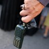 A man holds an Icom walkie talkie device after he removed the battery during the funeral of persons killed when hundreds of paging devices exploded in a deadly wave across Lebanon the previous day, in Beirut's southern suburbs on September 18, 2024.