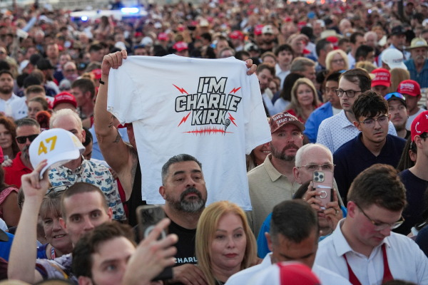 People wait in line before a memorial for conservative activist Charlie Kirk Sunday, Sept. 21, 2025, at State Farm Stadium in Glendale, Ariz.