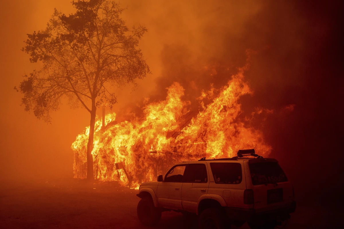 Flames consume a building as the Park Fire tears through the Cohasset community in Butte County, Calif., on Thursday.