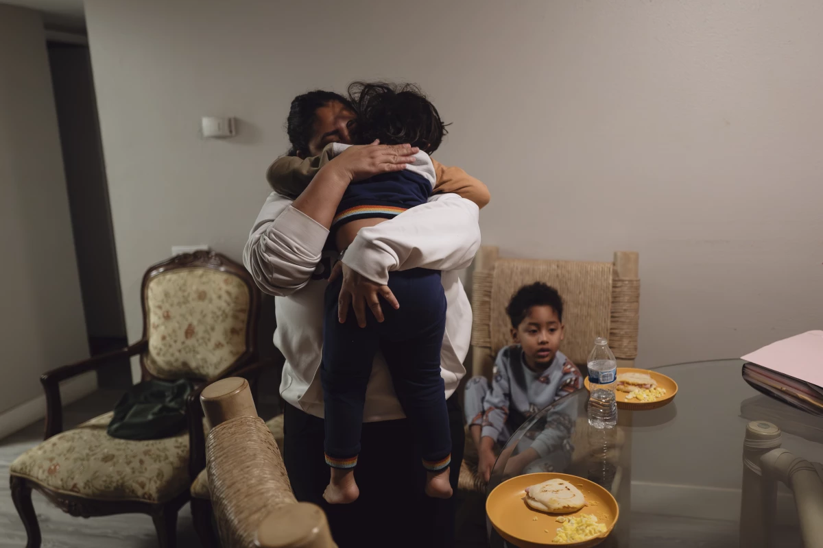 Yasmelin Valazquez wakes up her two sons at 3:30 in the morning to have breakfast before they leave for immigration court. April 10, 2025.