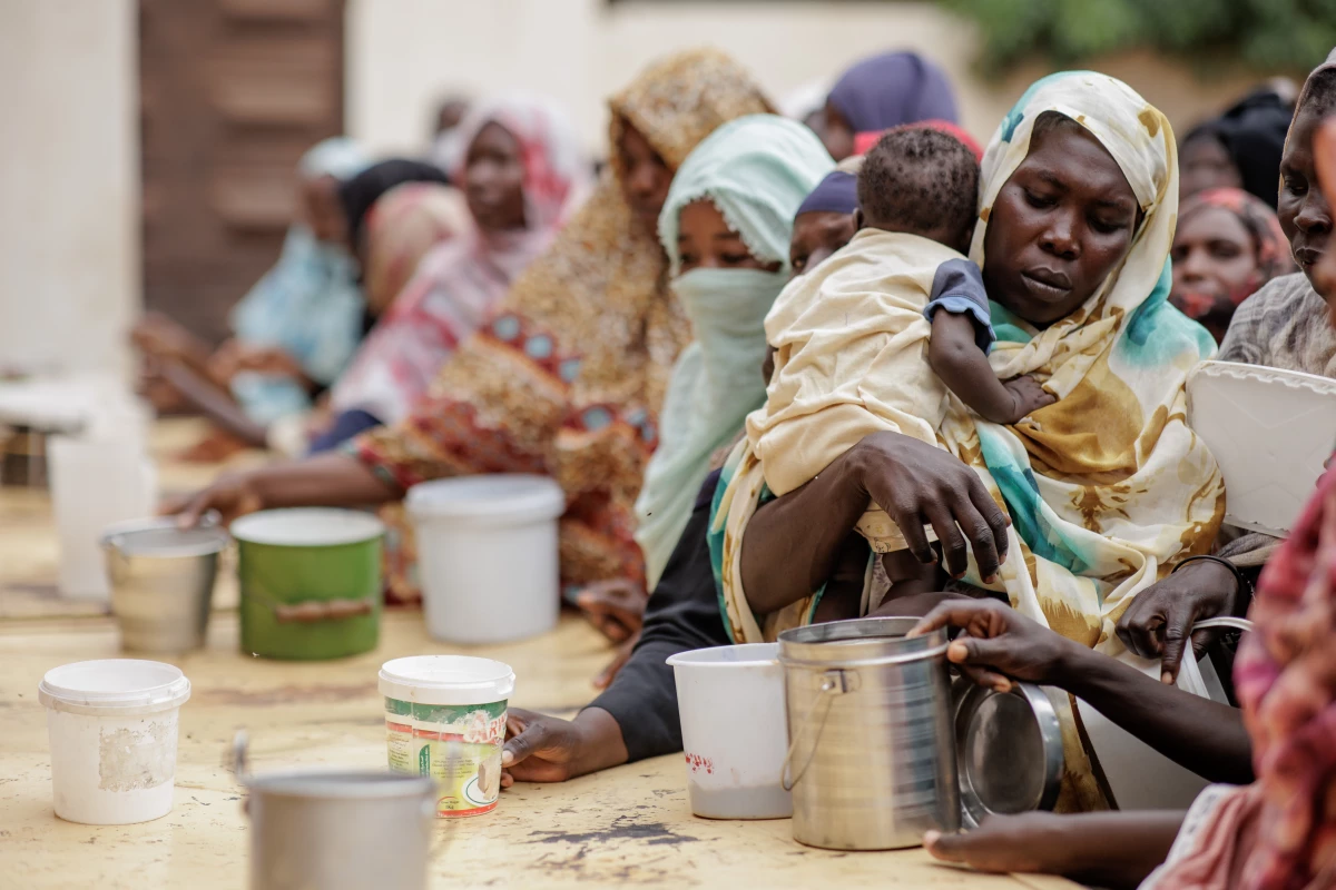 Women receive food from Friday Meals Sharing Kitchen in Omdurman, Sudan, on Sept. 6.
