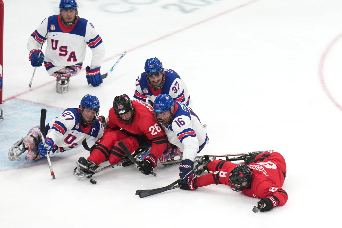 Team USA's Declan Farmer, center, fights for the puck during the gold-medal match against Canada.