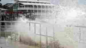 Surf from Tropical Storm Debby breaks over a sea wall in Cedar Key, Fla., in August 2024.