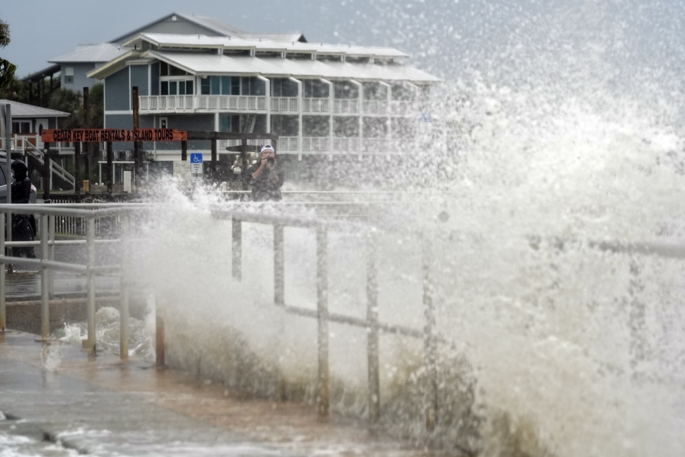 Surf from Tropical Storm Debby breaks over a sea wall in Cedar Key, Fla., in August 2024. Abnormally hot ocean water is contributing to a very active Atlantic Hurricane season. Climate change is the main driver of record-breaking ocean temperatures, but scientists are trying to figure out what other causes may be at play. (AP)