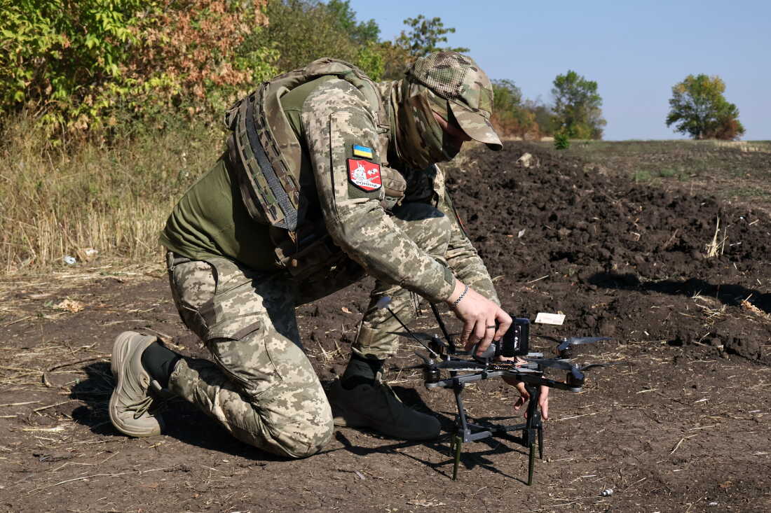 In this photo provided by Ukraine's 65th Mechanized Brigade press service, a Ukrainian soldier prepares an FPV drone to fire towards Russian positions in Zaporizhzhia region, Ukraine, Saturday, Sept. 19, 2026.