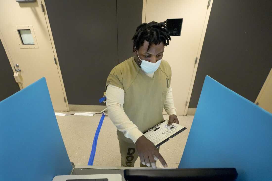 Tykarri Skillon, an inmate at the Cook County, Ill., jail, votes in a local election at the jail's Division 11 Chapel in Chicago.